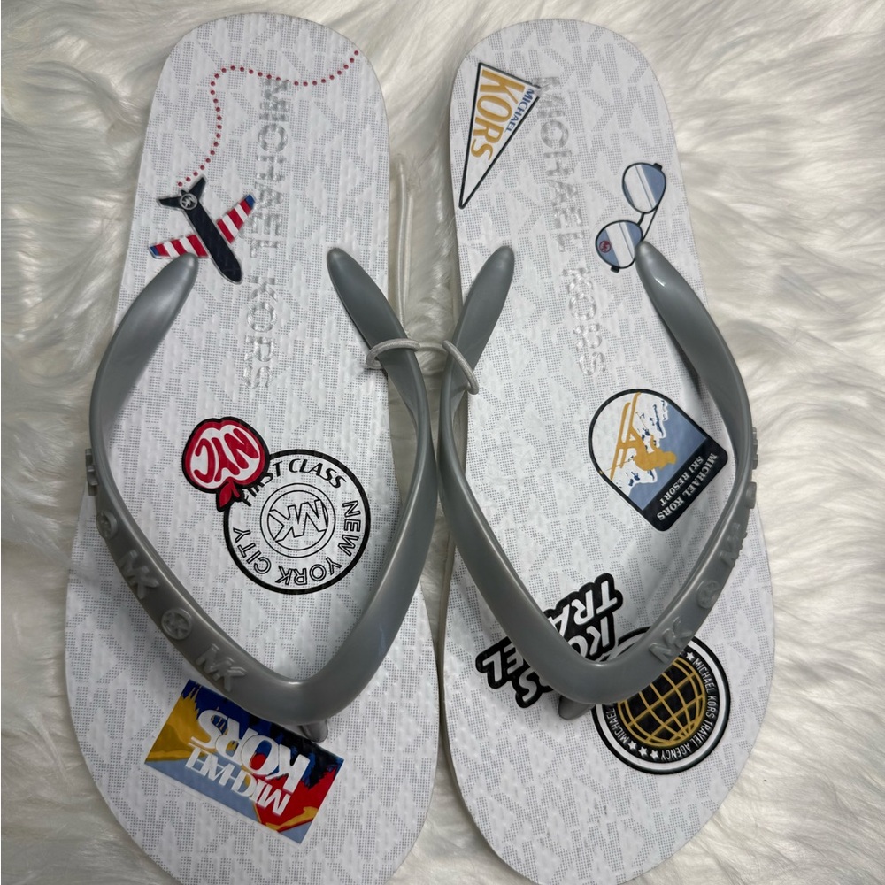 Michael Kors White Flip Flops with Gray Straps and Travel Patch Print
